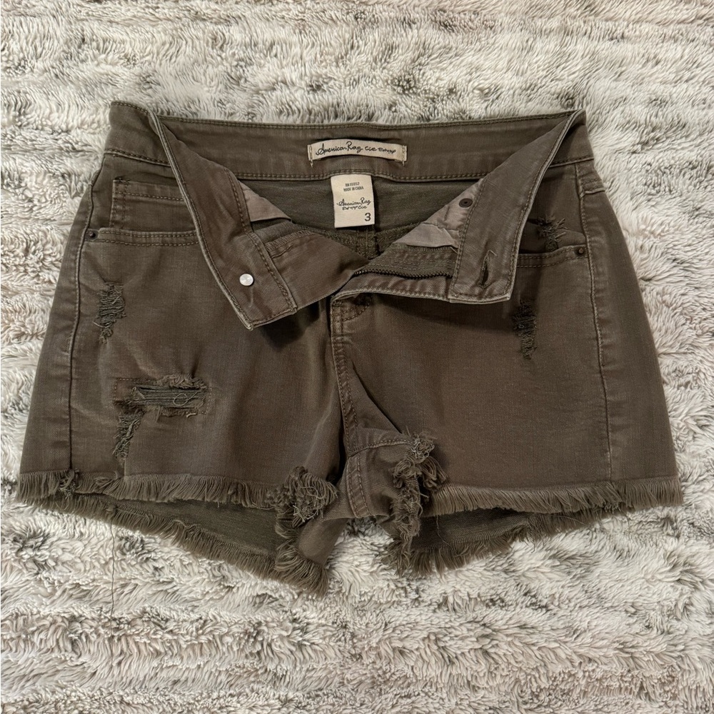 Army green ripped cutoff shorts